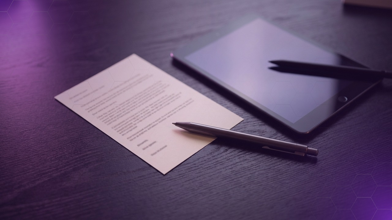 Overhead view of a dispensing desk with a printed script card, a tablet, and a pen, dark surface with soft purple accent light